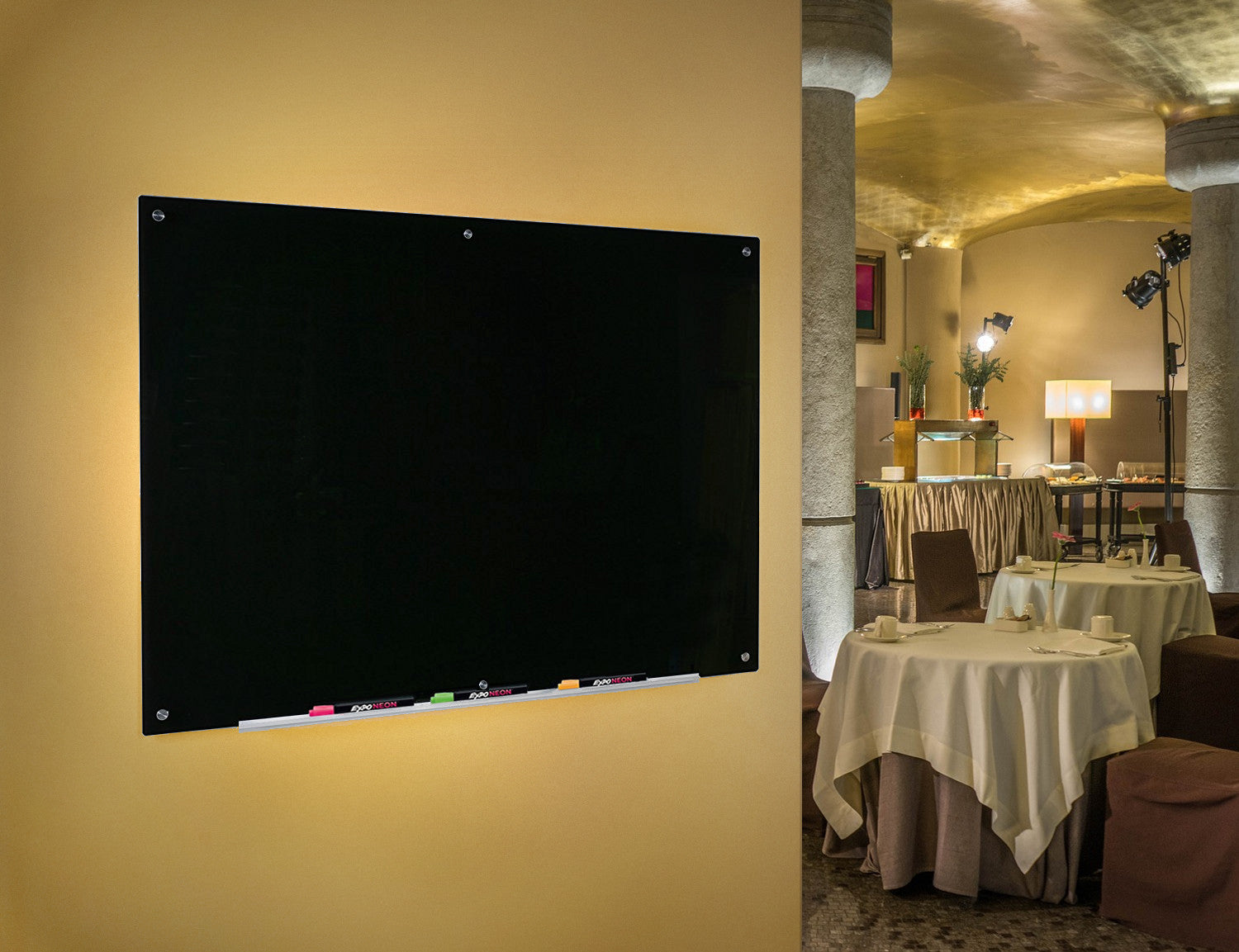 Black Glass Dry-Erase Board with Aluminum Marker Tray. Wall mounted in a restaurant to show use as a menu board.  