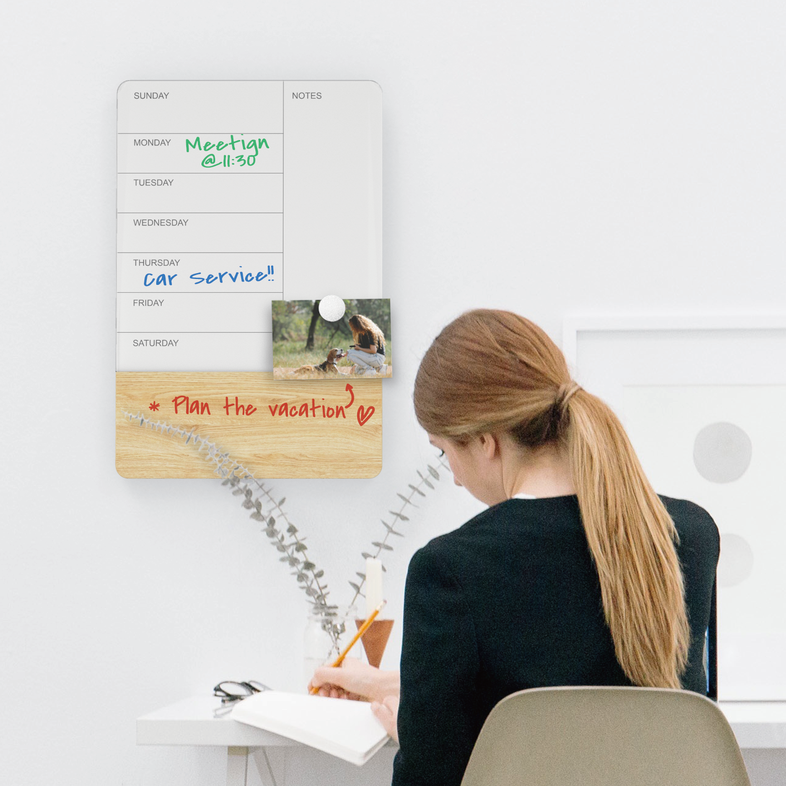 Wall Mounted Weekly Planner with person planning out their schedule. 