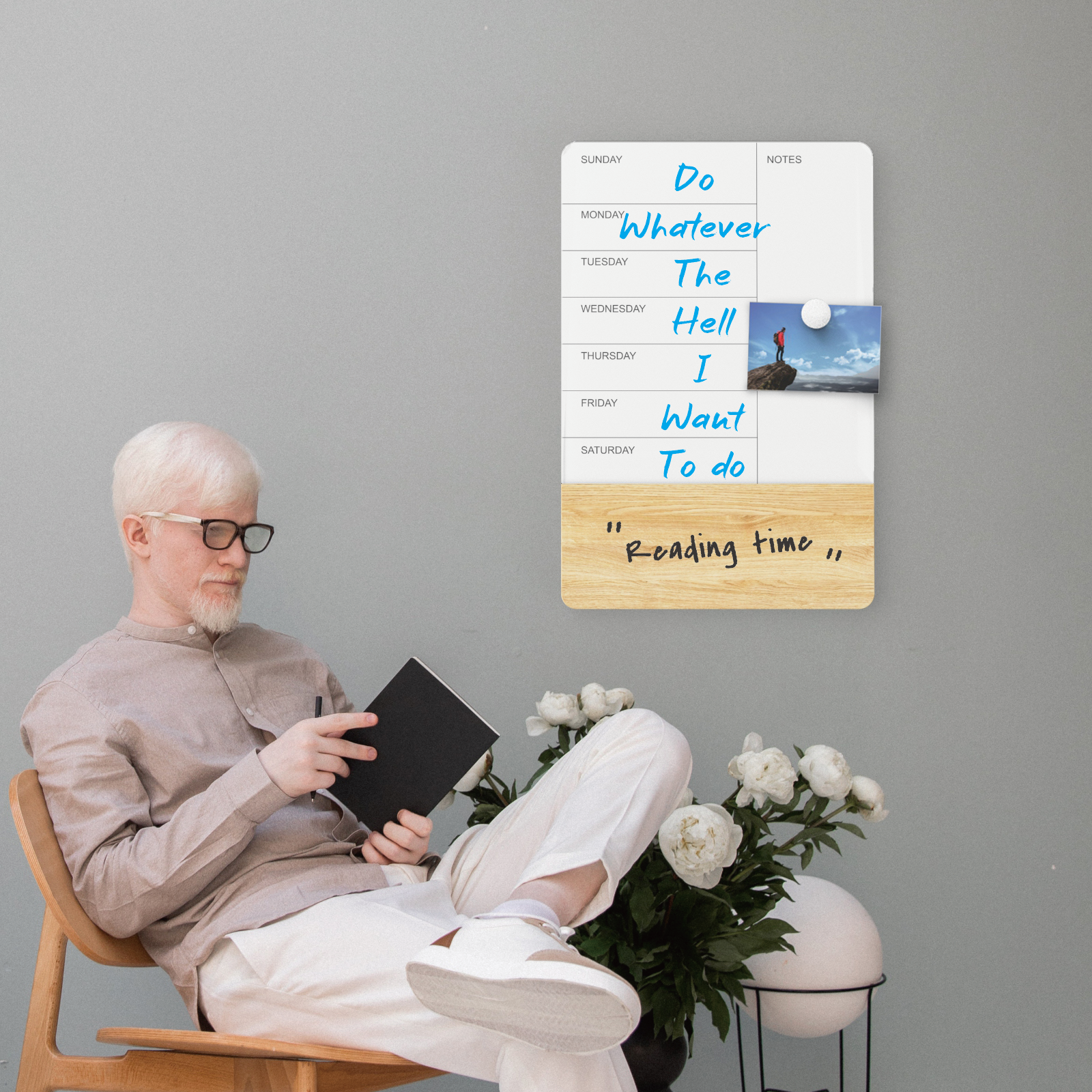 Man relaxing after writing out schedule on a board. 