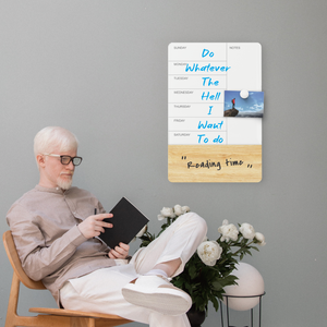 Man relaxing after writing out schedule on a board. 