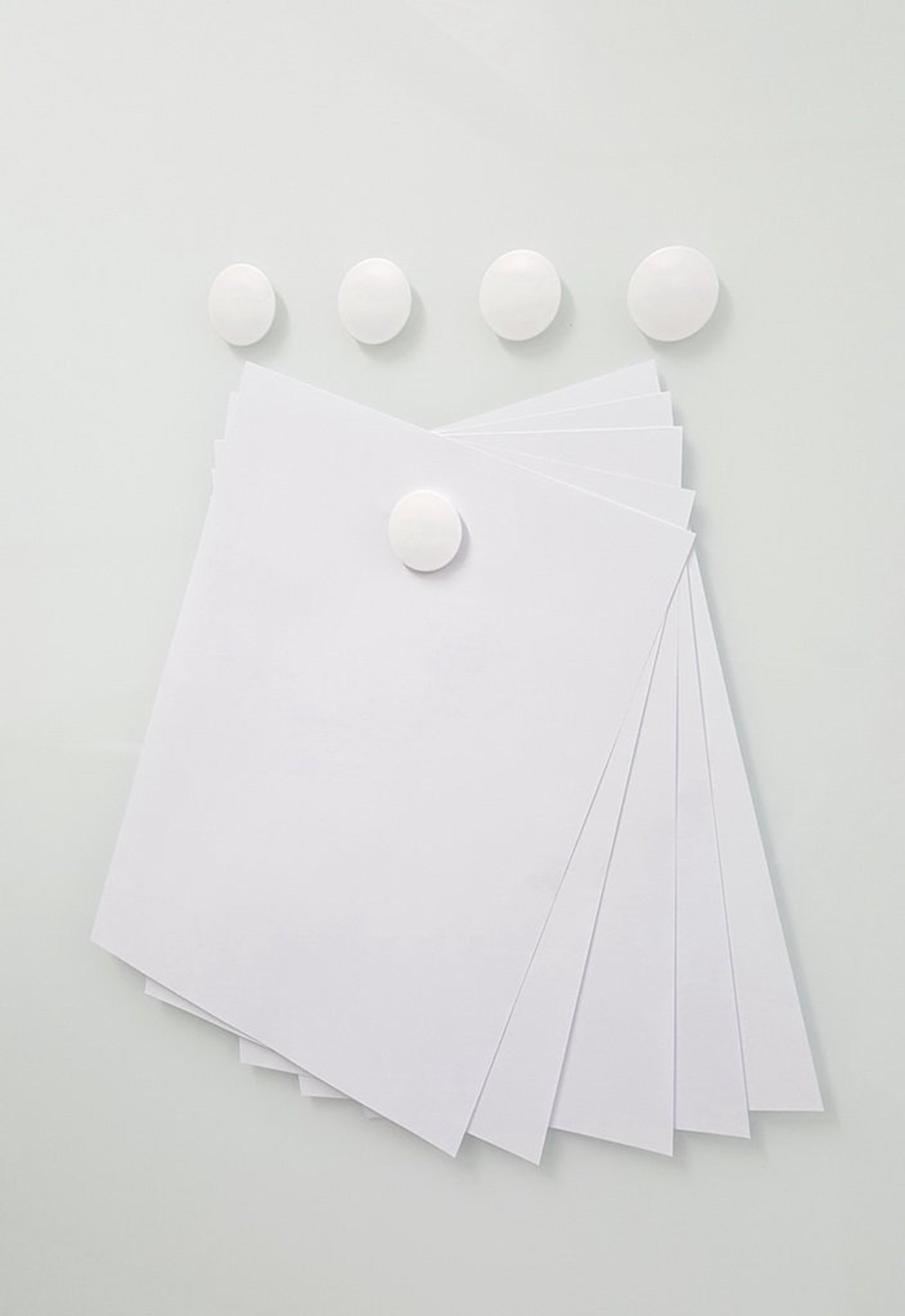High Powered Magnets for Glass Dry-Erase Boards, Set of 5 White. Holding paper on a glass board. 