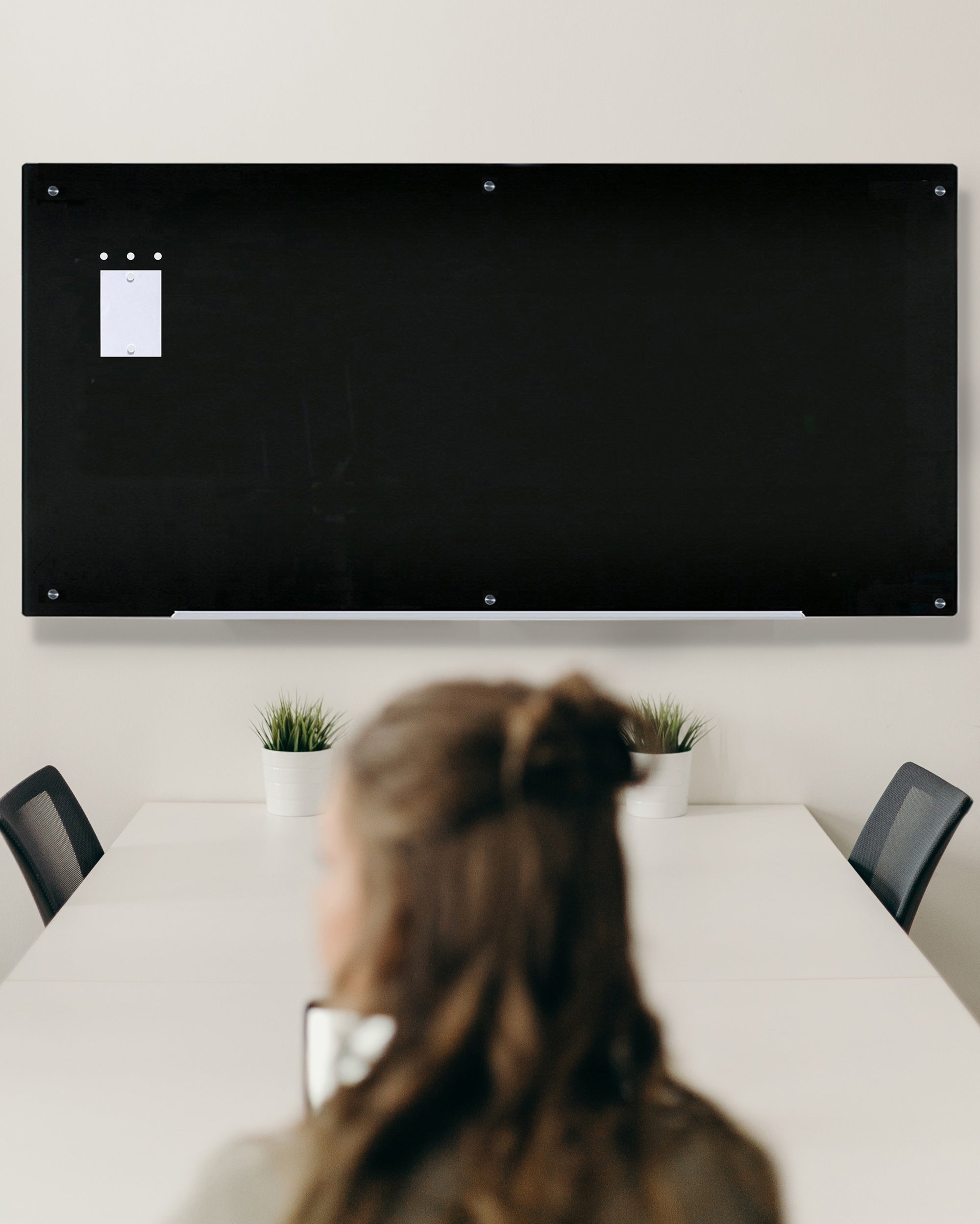 Extra Large Wall Mounted 48" x 96" Magnetic Black Board in a conference room. Shown with 5 neodymium magnets and a marker tray. 