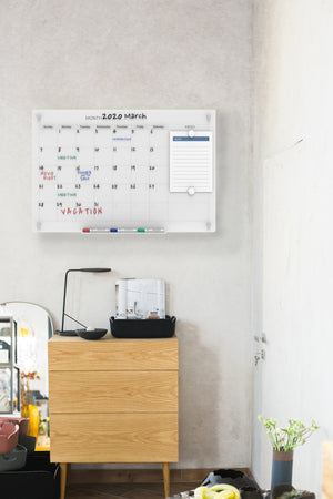 Audio-Visual Direct Magnetic Ultra White 30 Day Monthly Calendar Glass Dry-Erase Board Set in a Bedroom Setting. 